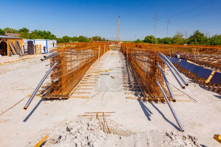 Stahlrohre zum Einführen von Kabeln, die durch quadratische Bewehrungsnetze gezogen werden und zur Festigkeit des Brückenskeletts auf der Baustelle platziert werden.