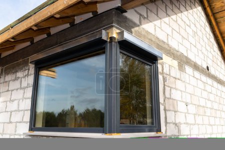 Photo for Warm installation of a three-layer window with a polystyrene window sill, view from the outside. - Royalty Free Image