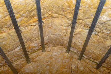 Foto de Aluminum frame with hangers placed on beams in the attic for mounting plasterboards. - Imagen libre de derechos