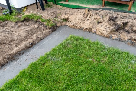 Photo for Foundation footings poured in a ditch in the yard, building a terrace in the backyard - Royalty Free Image