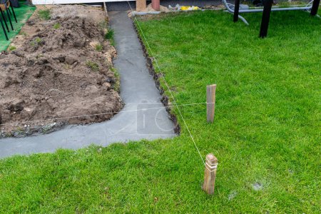 Photo for Foundation footings poured in a ditch in the yard, building a terrace in the backyard. - Royalty Free Image