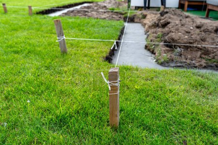 Photo for Foundation footings poured in a ditch in the yard, building a terrace in the backyard. - Royalty Free Image