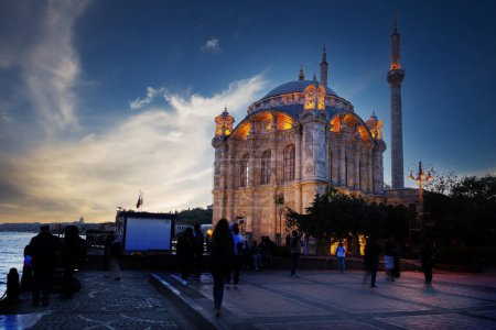 Photo for Ortakoy Mosque on the banks of the Bosphorus at sunset. Istanbul, Turkey. Peoples faces - Royalty Free Image