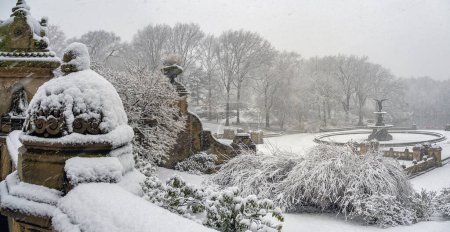 Photo for Bethesda Terrace and Fountain are two architectural features overlooking The Lake in New York City's Central Park, during snow storm - Royalty Free Image