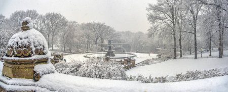 Photo for Bethesda Terrace and Fountain are two architectural features overlooking The Lake in New York City's Central Park, during snow storm - Royalty Free Image