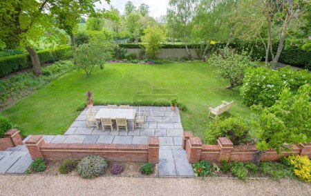 Garden patio furniture and large lawn in luxury back garden, UK
