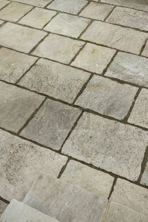 Photo for Dirty grey garden patio paving slabs before cleaning. UK garden with sandstone paving. - Royalty Free Image