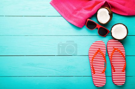 Photo for Summer accessories for modern woman on her vacation. Top view. Blue wooden background - Royalty Free Image
