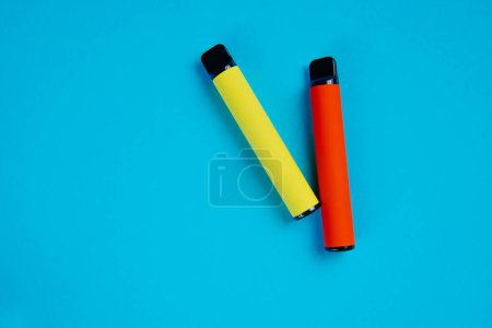 Photo for Two disposable e-cigarettes on a dark background. Electronic vape, an alternative to smoking cigarettes - Royalty Free Image