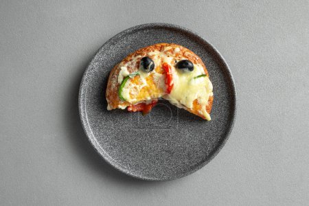 Photo for Slice of Indian pizza on a plate on a gray background. - Royalty Free Image