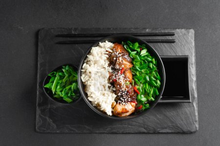 Photo for Teriyaki chicken rice bowl - asian food style. Asian food. Thai food. Rice with chicken and green onions on a dark background. Chinese food. Rice with spicy kung pao chicken on a plate. horizontal - Royalty Free Image