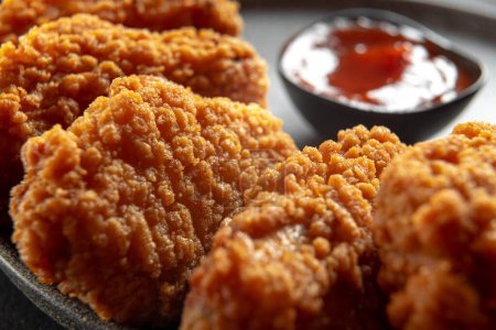 Photo for Fried chicken fillet on a dark background. Fried chicken wings as in KFC at home close-up - Royalty Free Image