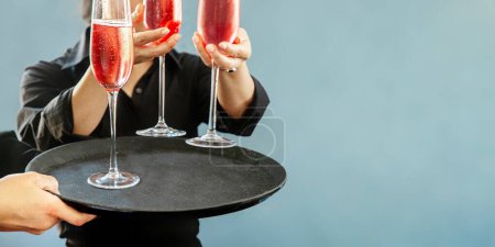Photo for Glass of red wine served by a professional caterer on blurred blue grey background. High quality photo - Royalty Free Image