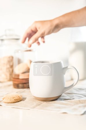 Foto de Cookies and morning drink coffee, milk or tea in light natural envoronment, kinfolk style breakfast. High quality photo - Imagen libre de derechos