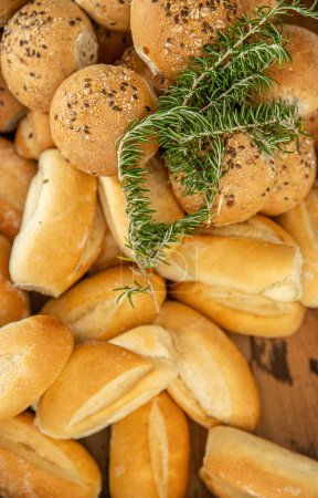 Photo for Fresh sourdough buns served for a celebration event or party decorated with rosemary. High quality photo - Royalty Free Image