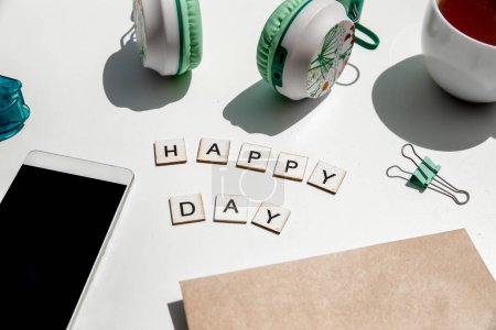 Photo for Happy day wording and metal paper clips isolated over white background, business concept, memory reminder paper, work or educational tools. High quality photo - Royalty Free Image