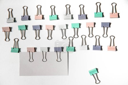 Photo for White note hold by metal paper clips isolated over white background, business concept, memory reminder paper, work or educational tools. High quality photo - Royalty Free Image