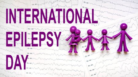 Téléchargez les photos : International Epilepsy Day, Epilepsy awareness. Purple toy adults and kids people, family and International Epilepsy Day text on brain wave on electroencephalogram EEG for epilepsy. - en image libre de droit