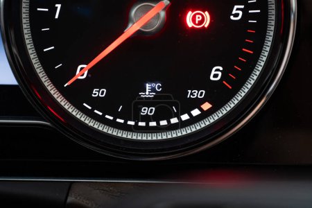 Photo for Modern car lit water or coolant temperature meter digital dial. Close up shot, rev meter above, no people. - Royalty Free Image