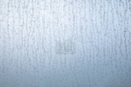 Dried hard water stains on shower window, close up shot, no people.