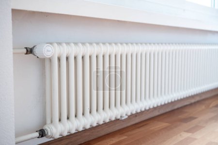 Photo for Cast iron ribbed radiator or heater inside apartment room. Close up shot, no people. - Royalty Free Image
