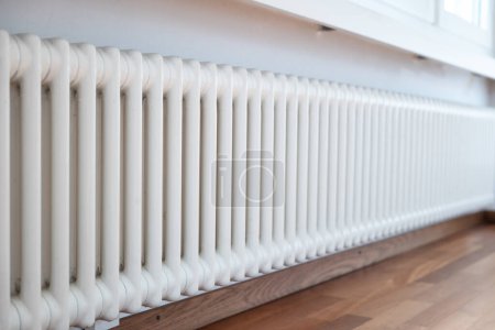 Photo for Cast iron ribbed radiator or heater inside apartment room. Close up shot, no people. - Royalty Free Image
