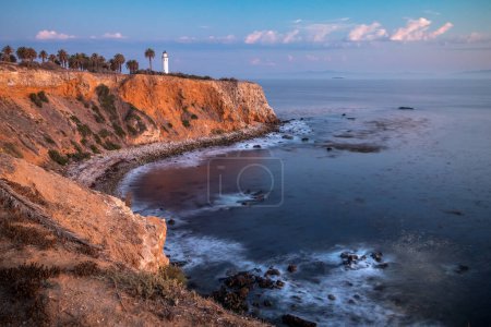 Tranquil sunset paints the sky above Point Vicente, casting golden hues over the rugged coastline, a serene moment in Rancho Palos Verdes, California.