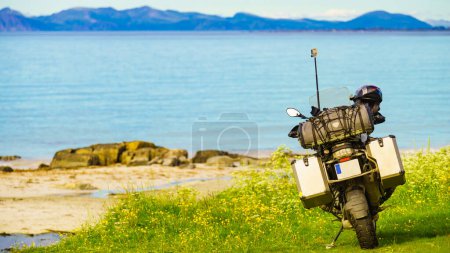 Motorcycle with box case storage on sea shore. Holidays trip