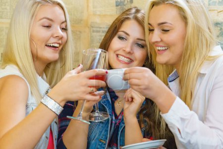 Girls with alcohol glass in night club. Celebration, friends and bachelorette party concept.