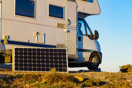 Portable solar photovoltaic panel, charging battery at camper vehicle.