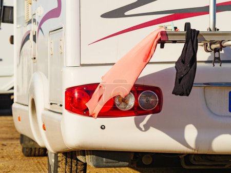 Wild camping on nature. Camper car rv with clothes hanging to dry. Holidays with motor home.