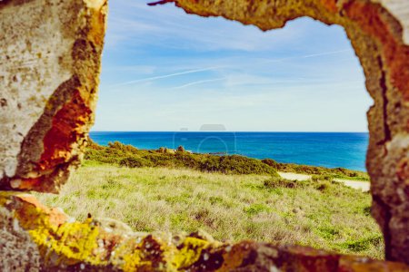 View from stone frame of sea landscape. Mediterranean coast, beach Torrecarbonera on Punta Mala, Alcaidesa in Spain.