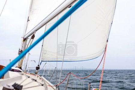 Sailing boat, idyllic view. Seascape from boat, mast riggging, foggy milky weather.
