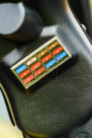 Close up of car fuse box in auto truck tractor machine vehicle. Electronics in transportation.