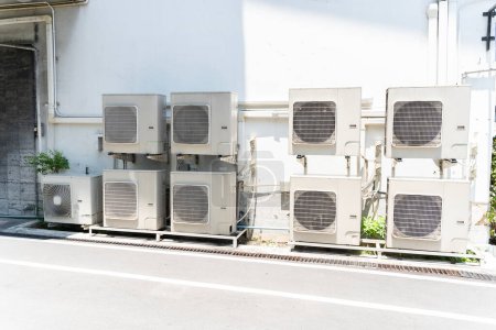 Air conditioning (HVAC) installed on the roof of industrial buildings. Air compressors concept.