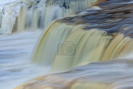 Photo for Winter landscape of Lower Tahquamenon Falls framed by ice and captured with motion blur, Michigan's Upper Peninsula, USA - Royalty Free Image