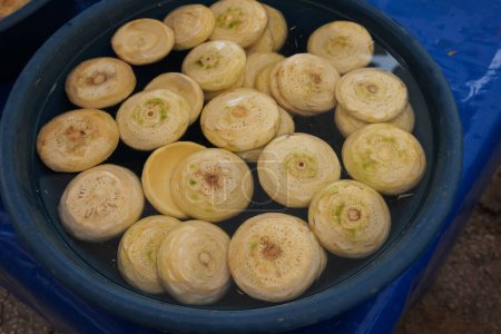 Fresh prepared peeled artichokes in plastic bowl at local market in Turkey