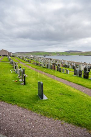 Photo for Graveyard Cemetery on Shetland Island on a hill with sea in the background during cloudy day, vertical shot - Royalty Free Image