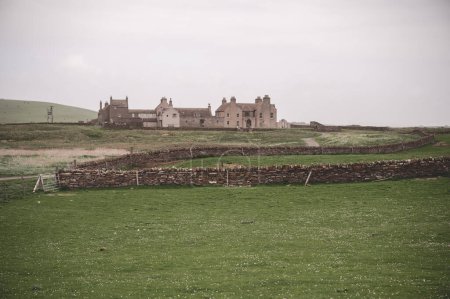 Photo for Skaill House at Orkney Island, with old stone wall and meadow in front, wide angle shot, Kirkwall, Scotland - Royalty Free Image