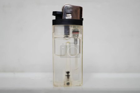 Transparent Lighter Against a White Background Showcasing Its Inner Mechanism