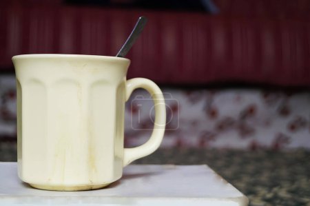 Cream-Colored Mug Filled With Beverage on a Marble Surface in a Cozy Room