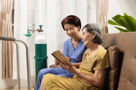 Caregiver takecare elderly woman while wearing oxygen nasal cannula at home.