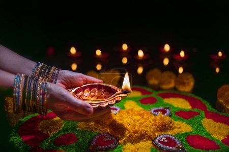 Photo for Clay diya lamps lit during diwali celebration, Diwali, or Deepavali, is India's biggest and most important holiday. - Royalty Free Image