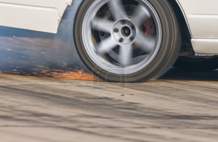 EV drift car is burning tires on speed track.
