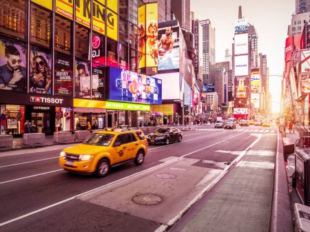 Foto de View of New York city in the USA at Times Square showcasing its lights, stores, traffic, and lots of tourists and locals passing by. - Imagen libre de derechos