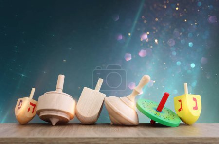 Photo for Image of jewish holiday Hanukkah and wooden dreidels collection. Spinning tops with letters that mean, a great miracle happened here - Royalty Free Image
