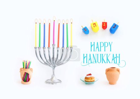 Photo for Image of jewish holiday Hanukkah background of menorah (traditional candelabra), doughnut and candles. Spinning tops with letters that mean, a great miracle happened here - Royalty Free Image