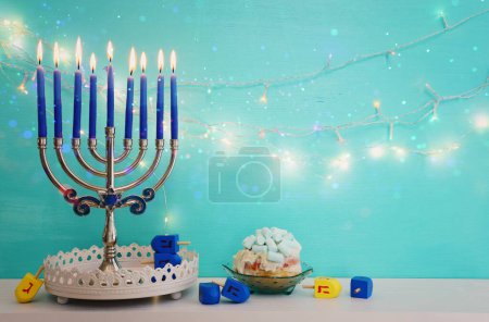 Photo for Religion image of jewish holiday Hanukkah background with menorah (traditional candelabra), doughnut and candles - Royalty Free Image