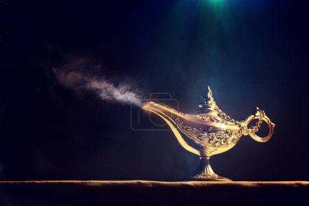 Photo for Image of magical mysterious aladdin lamp with glitter sparkle smoke over black background. Lamp of wishes - Royalty Free Image
