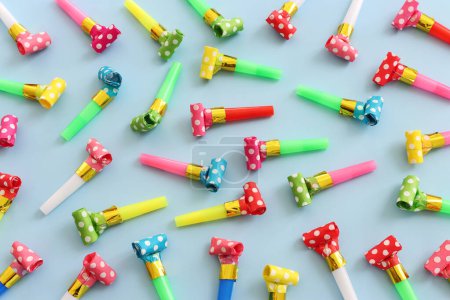 Photo for Collection of colorful party blowers on blue background. Concept of party or celebration - Royalty Free Image